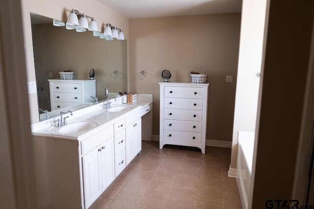 full bath with double vanity, tile patterned flooring, and a sink