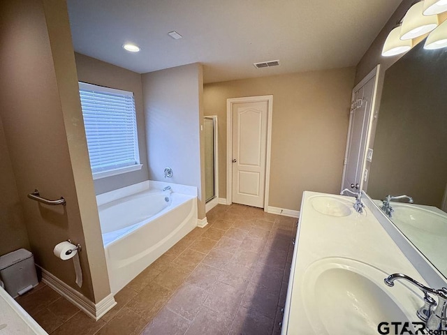 full bath featuring a bath, a sink, visible vents, and a shower stall