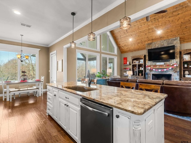 11087 Wolverine Rd, Pittsburg, TX 75686 - kitchen with stainless steel dishwasher, open floor plan, a sink, a stone fireplace, and vaulted ceiling