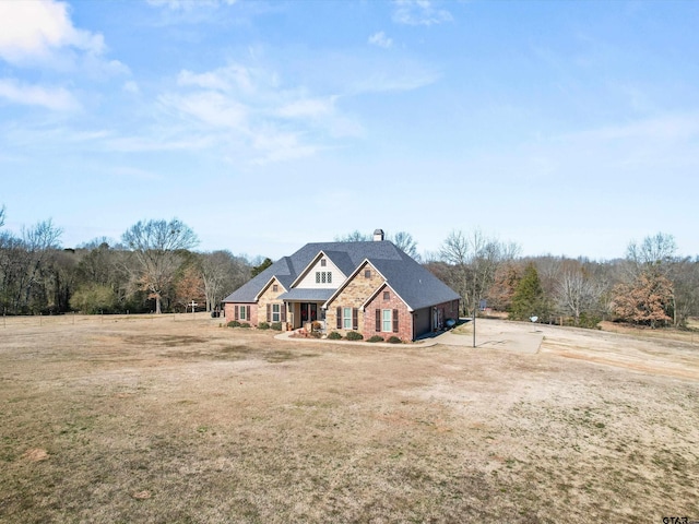 11087 Wolverine Rd, Pittsburg, TX 75686 - craftsman house with a chimney, a front yard, and brick siding