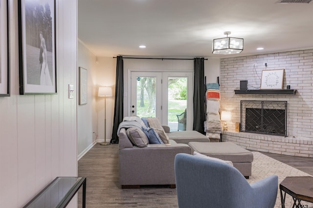 8116 Jewell Ln, Tyler, TX 75703 - living room featuring a fireplace, wood finished floors, a chandelier, baseboards, and recessed lighting