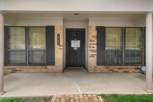 8116 Jewell Ln, Tyler, TX 75703 - doorway to property with brick siding and covered porch