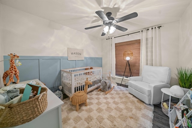8116 Jewell Ln, Tyler, TX 75703 - bedroom featuring ceiling fan, a wainscoted wall, and a decorative wall
