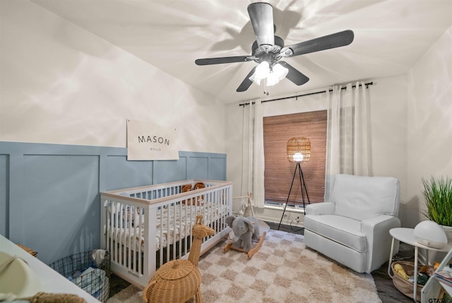 8116 Jewell Ln, Tyler, TX 75703 - bedroom with a crib, ceiling fan, and wainscoting
