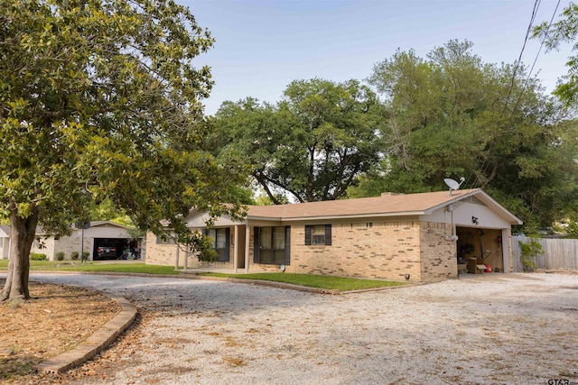 8116 Jewell Ln, Tyler, TX 75703 - ranch-style house with brick siding, curved driveway, and fence