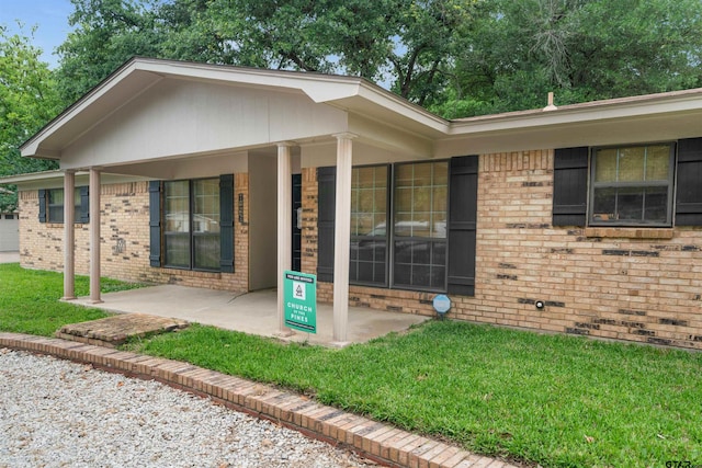8116 Jewell Ln, Tyler, TX 75703 - entrance to property featuring brick siding and a lawn