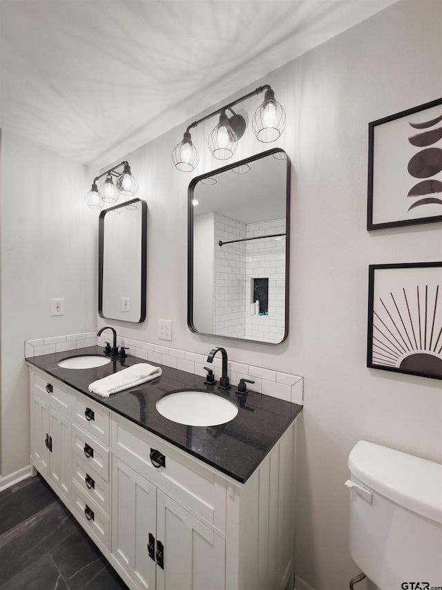 8116 Jewell Ln, Tyler, TX 75703 - bathroom with toilet, double vanity, baseboards, and backsplash