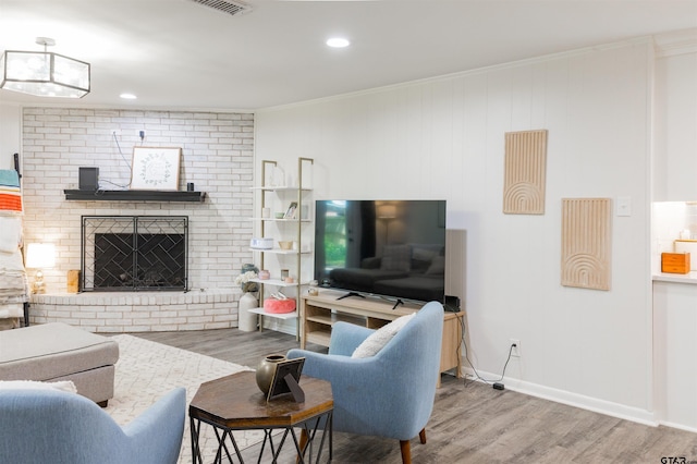 8116 Jewell Ln, Tyler, TX 75703 - living area with wood finished floors, crown molding, a brick fireplace, baseboards, and recessed lighting