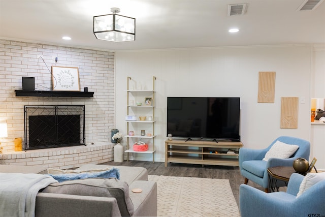 8116 Jewell Ln, Tyler, TX 75703 - living room featuring wood finished floors, ornamental molding, a brick fireplace, and recessed lighting