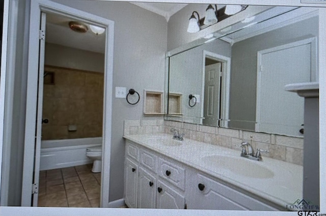 3729 Linda Kaye Dr, Longview, TX 75604 - bathroom with double vanity, toilet, a tub to relax in, a sink, and tile patterned flooring
