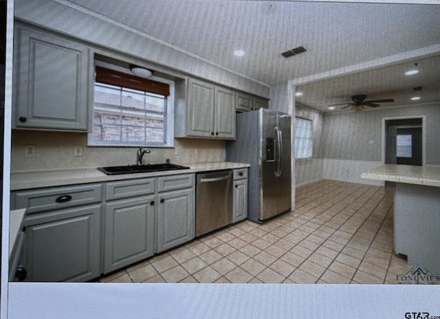 3729 Linda Kaye Dr, Longview, TX 75604 - kitchen with light countertops, a sink, gray cabinetry, stainless steel appliances, and ceiling fan
