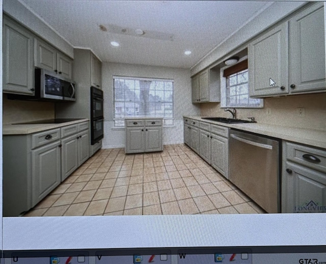 3729 Linda Kaye Dr, Longview, TX 75604 - kitchen featuring gray cabinets, black appliances, light countertops, and a sink