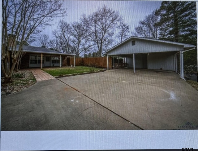 3729 Linda Kaye Dr, Longview, TX 75604 - view of home's exterior featuring concrete driveway and fence