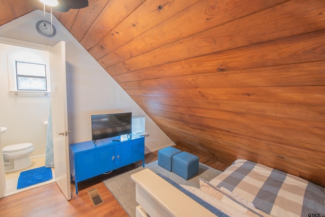 unfurnished bedroom featuring wood-type flooring, wood ceiling, connected bathroom, and vaulted ceiling