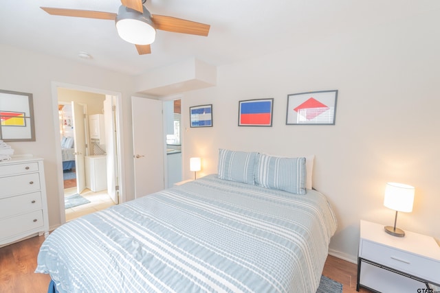 bedroom with ceiling fan, connected bathroom, and light hardwood / wood-style flooring