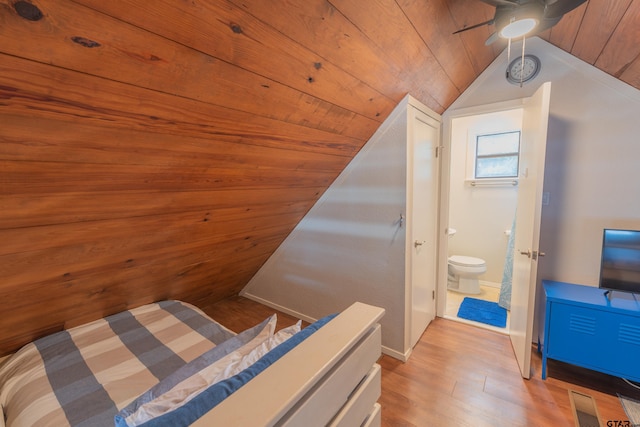 bedroom with wooden ceiling, ensuite bathroom, ceiling fan, light hardwood / wood-style flooring, and vaulted ceiling