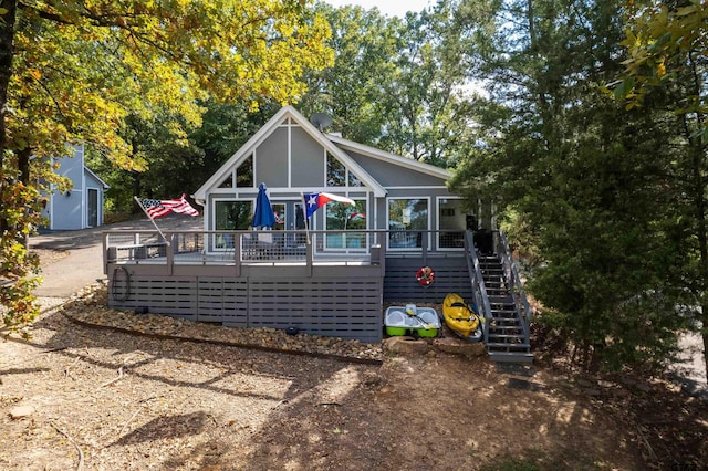 back of property featuring a wooden deck