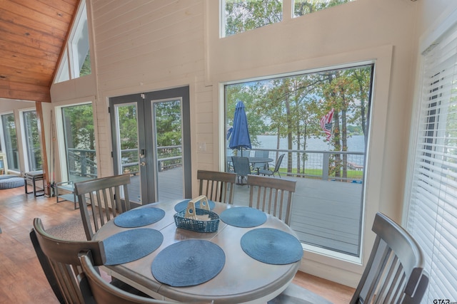 dining room with wood-type flooring, high vaulted ceiling, wood ceiling, and french doors