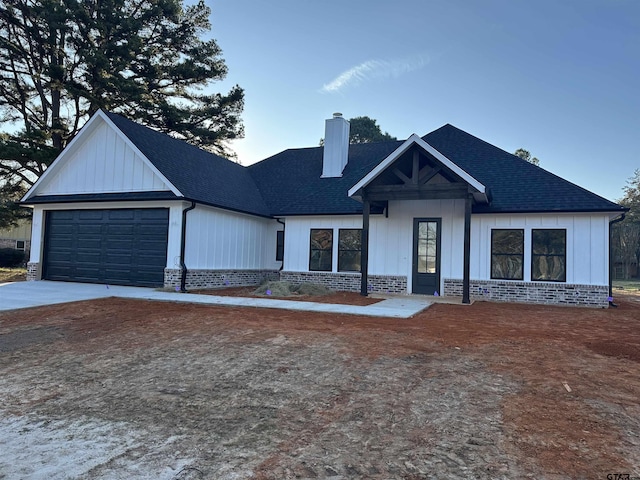 modern inspired farmhouse with a garage