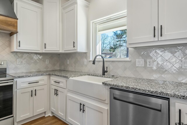 kitchen featuring light wood-type flooring, custom range hood, beam ceiling, white cabinets, and a kitchen island