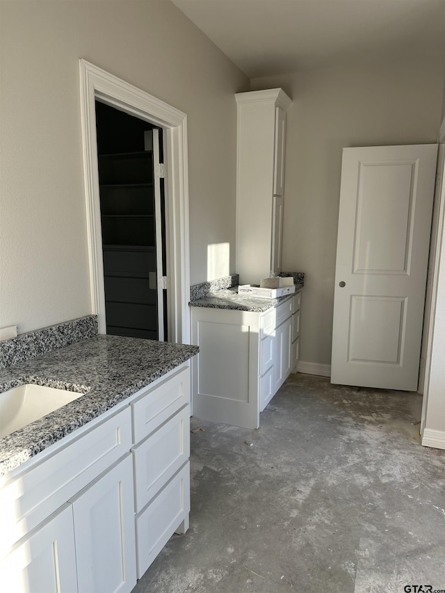 bathroom featuring sink and concrete floors