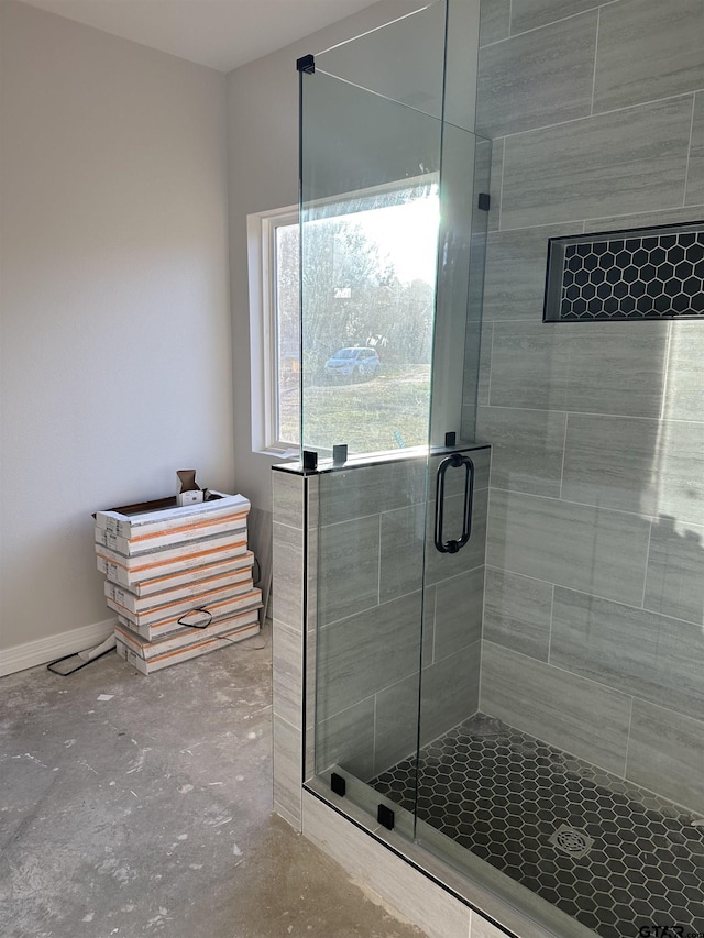 bathroom featuring a shower with shower door