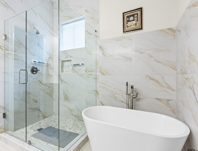 9109 Long Br, Tyler, TX 75703 - bathroom featuring tile walls, a freestanding tub, and a marble finish shower