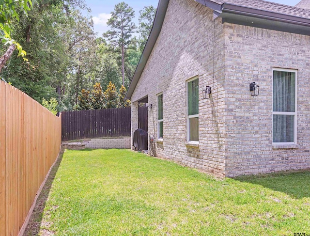 9109 Long Br, Tyler, TX 75703 - view of side of home with brick siding, a fenced backyard, and a shingled roof