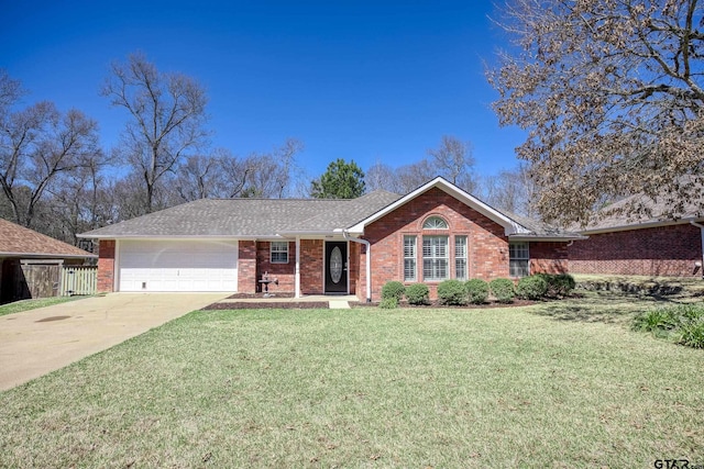 ranch-style house with brick siding, concrete driveway, and a front yard