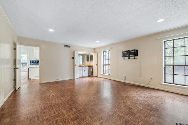 725 Purdue Dr, Tyler, TX 75701 - unfurnished living room with a textured ceiling and recessed lighting