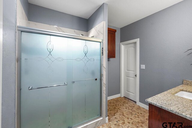 5900 Fm 858, Ben Wheeler, TX 75754 - full bathroom featuring a stall shower, vanity, and baseboards