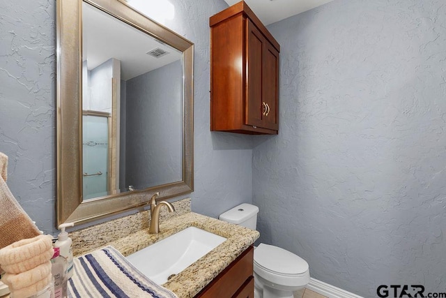 5900 Fm 858, Ben Wheeler, TX 75754 - bathroom featuring a textured wall, toilet, vanity, and a shower