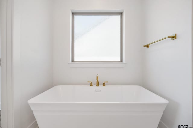 bathroom with a tub and sink