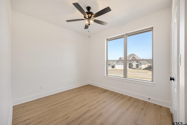 empty room with light wood-type flooring and ceiling fan