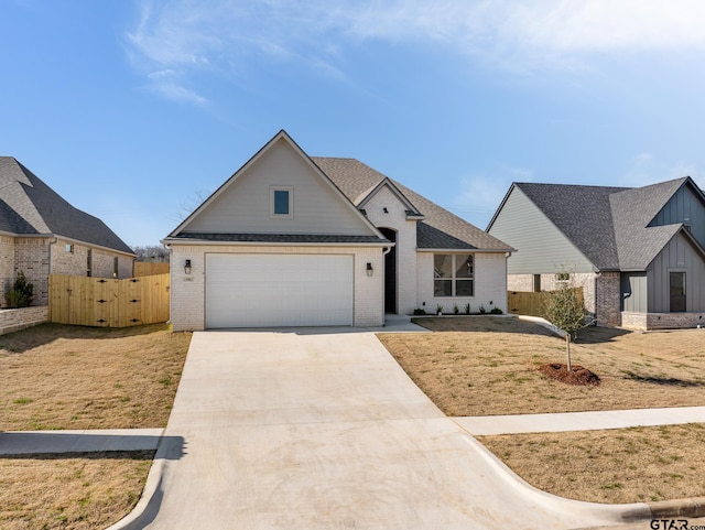 view of front of home featuring a garage and a front yard