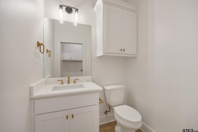 bathroom featuring toilet and vanity