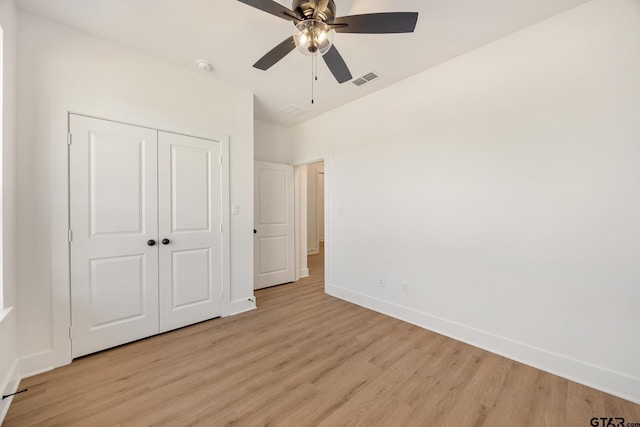 unfurnished bedroom with a closet, ceiling fan, and light wood-type flooring