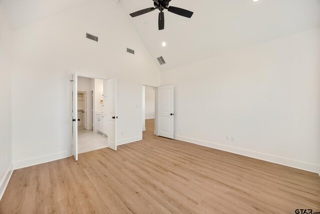 unfurnished bedroom with ceiling fan, high vaulted ceiling, and light wood-type flooring