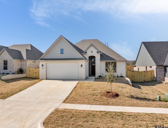 view of front facade featuring a garage and a front lawn