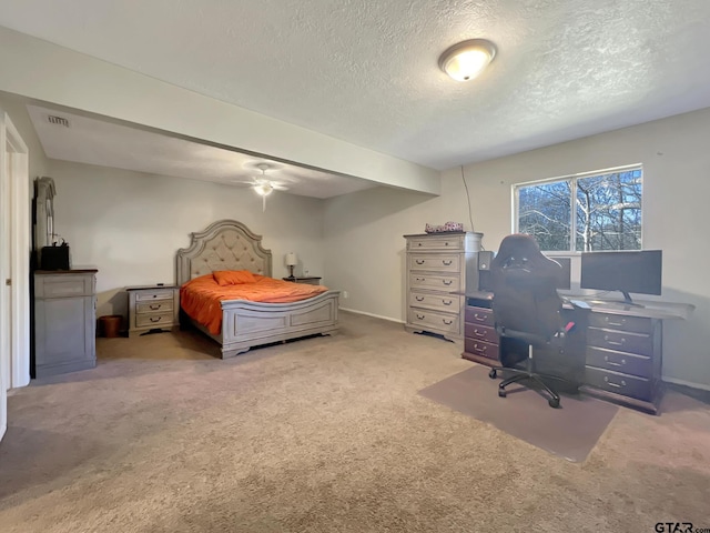 carpeted bedroom featuring ceiling fan and a textured ceiling