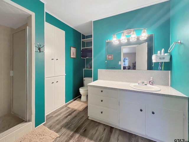 bathroom with vanity, wood-type flooring, toilet, and walk in shower