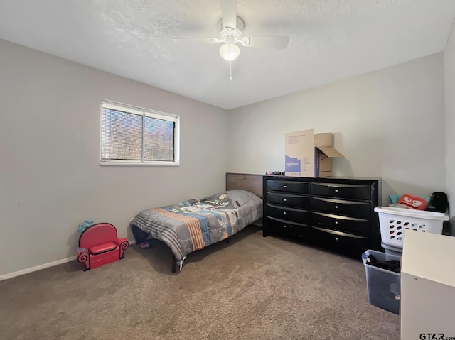 bedroom with ceiling fan, a textured ceiling, and carpet flooring