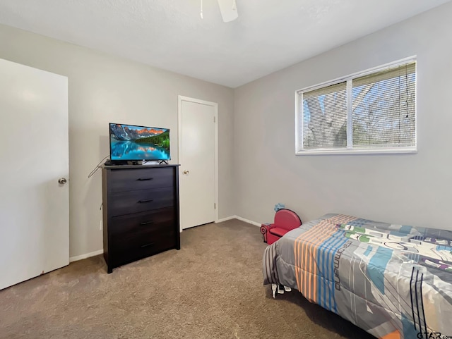 bedroom with ceiling fan and light carpet