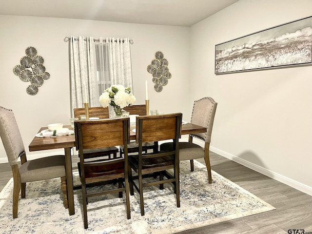 202 Parker Oaks, Chandler, TX 75758 - dining area with baseboards and wood finished floors