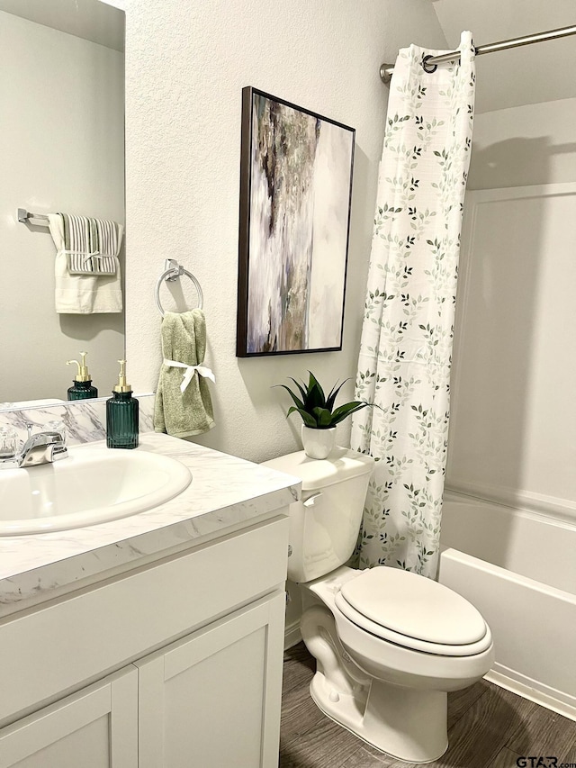 202 Parker Oaks, Chandler, TX 75758 - full bath featuring toilet, vanity, shower / bath combo, wood finished floors, and a textured wall