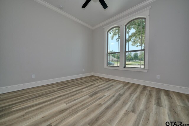 93 S Ryder Cup, Hideaway, TX 75771 - unfurnished room with crown molding, baseboards, a ceiling fan, and a wealth of natural light