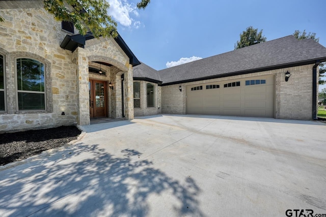 93 S Ryder Cup, Hideaway, TX 75771 - french country home featuring concrete driveway, brick siding, an attached garage, and stone siding