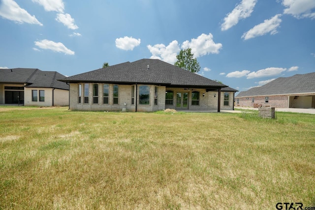 93 S Ryder Cup, Hideaway, TX 75771 - rear view of property featuring a ceiling fan, a shingled roof, a yard, and brick siding