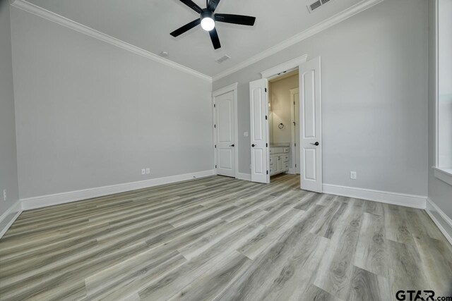 93 S Ryder Cup, Hideaway, TX 75771 - unfurnished bedroom featuring visible vents, light wood-type flooring, baseboards, connected bathroom, and ornamental molding