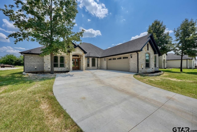 93 S Ryder Cup, Hideaway, TX 75771 - french country style house featuring an attached garage, driveway, stone siding, and a front lawn